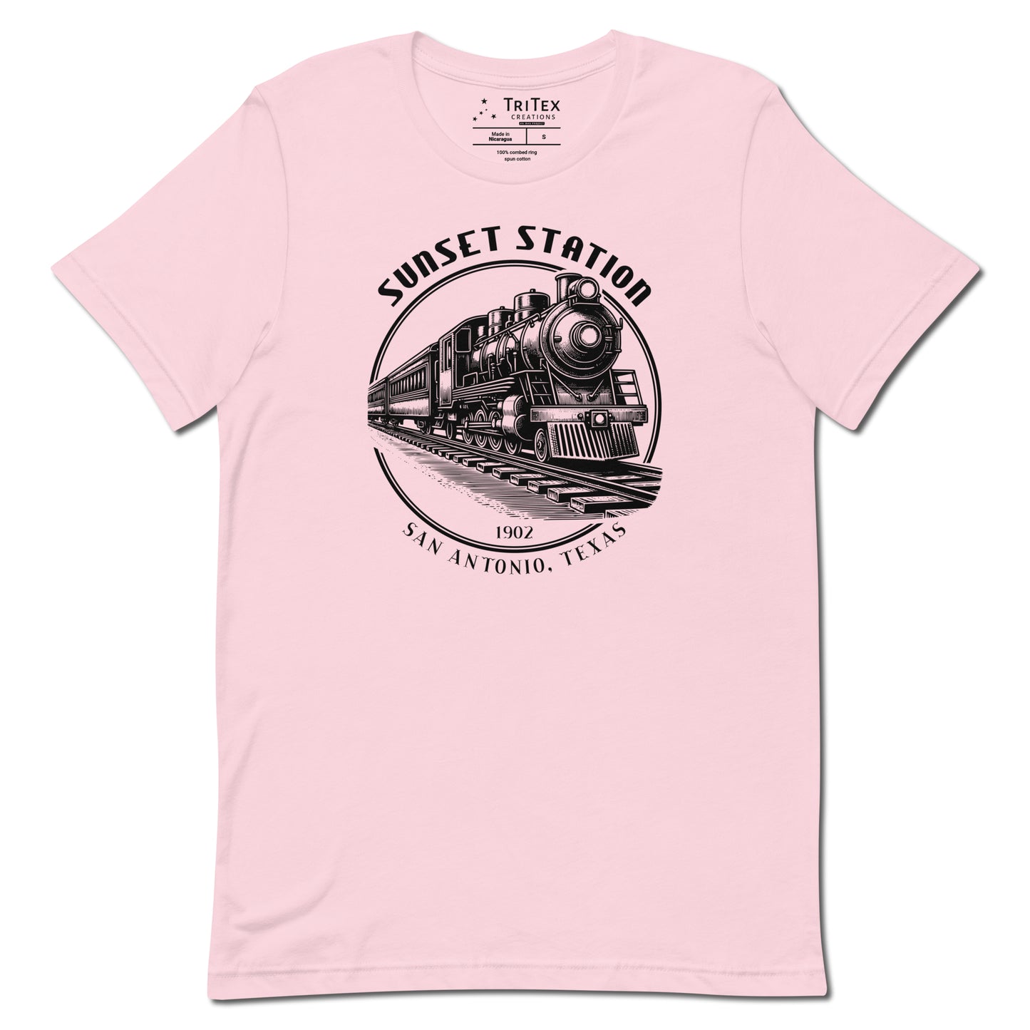 A soft pink t-shirt featuring a vintage locomotive  with the words "Sunset Station. 1902. San Antonio, Texas".