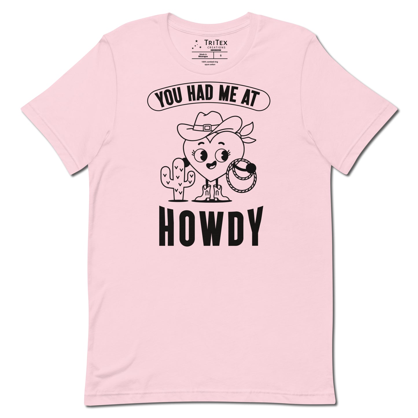 A soft pink t-shirt featuring a cartoon heart dressed like a cowboy with the words "You has me at howdy".