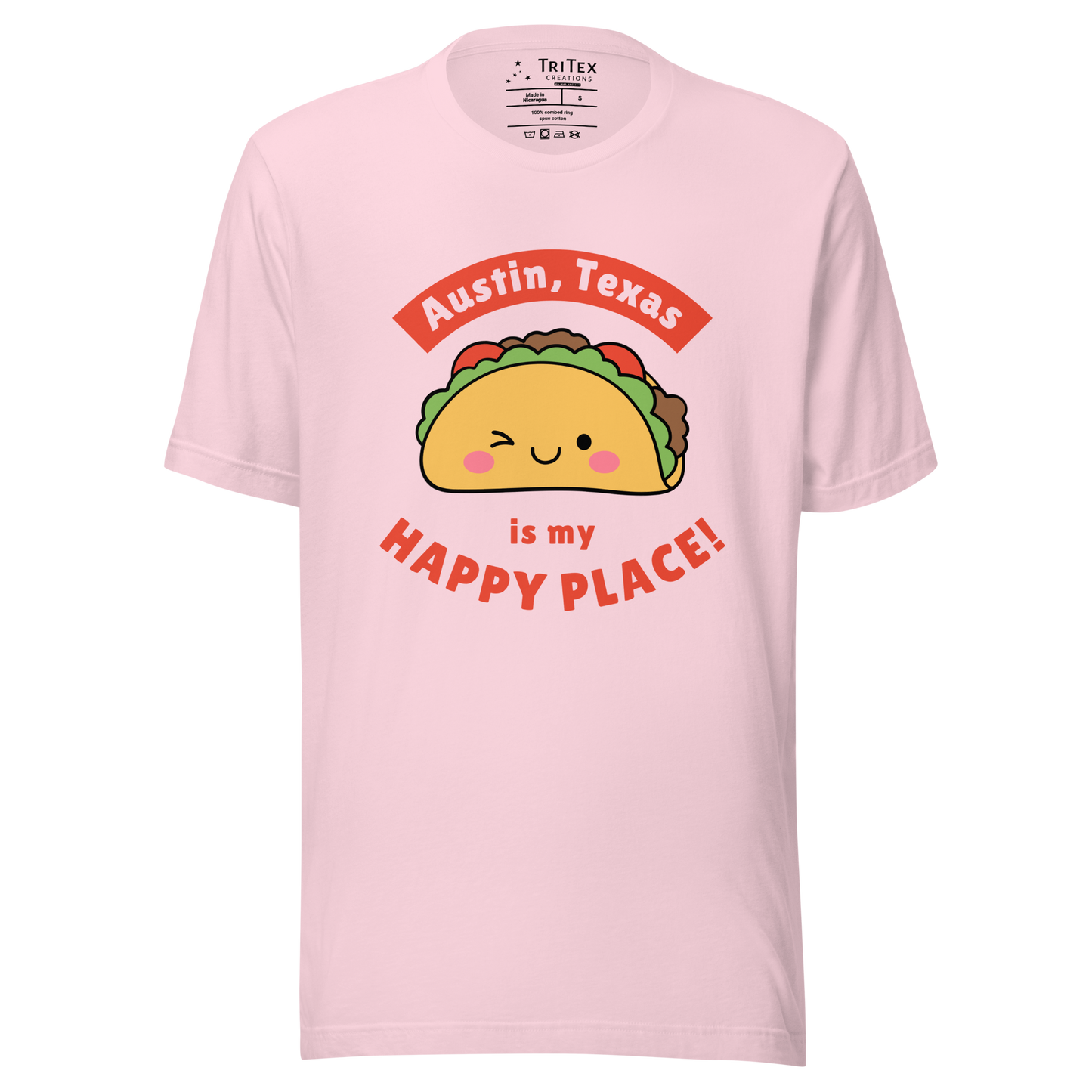 A soft pink t-shirt featuring a smiling, winking cartoon taco with the words "Austin, Texas is my happy place!".