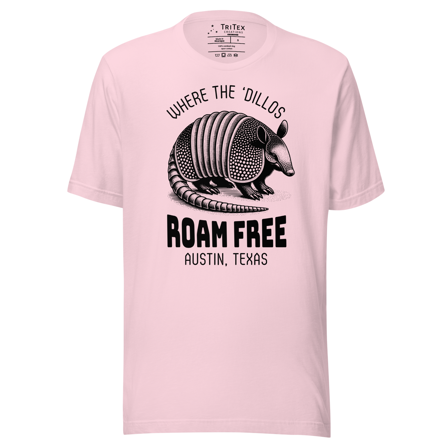 A soft pink t-shirt featuring a vintage illustration of an armadillo with the words "Where the 'dillos roam free. Austin, Texas".