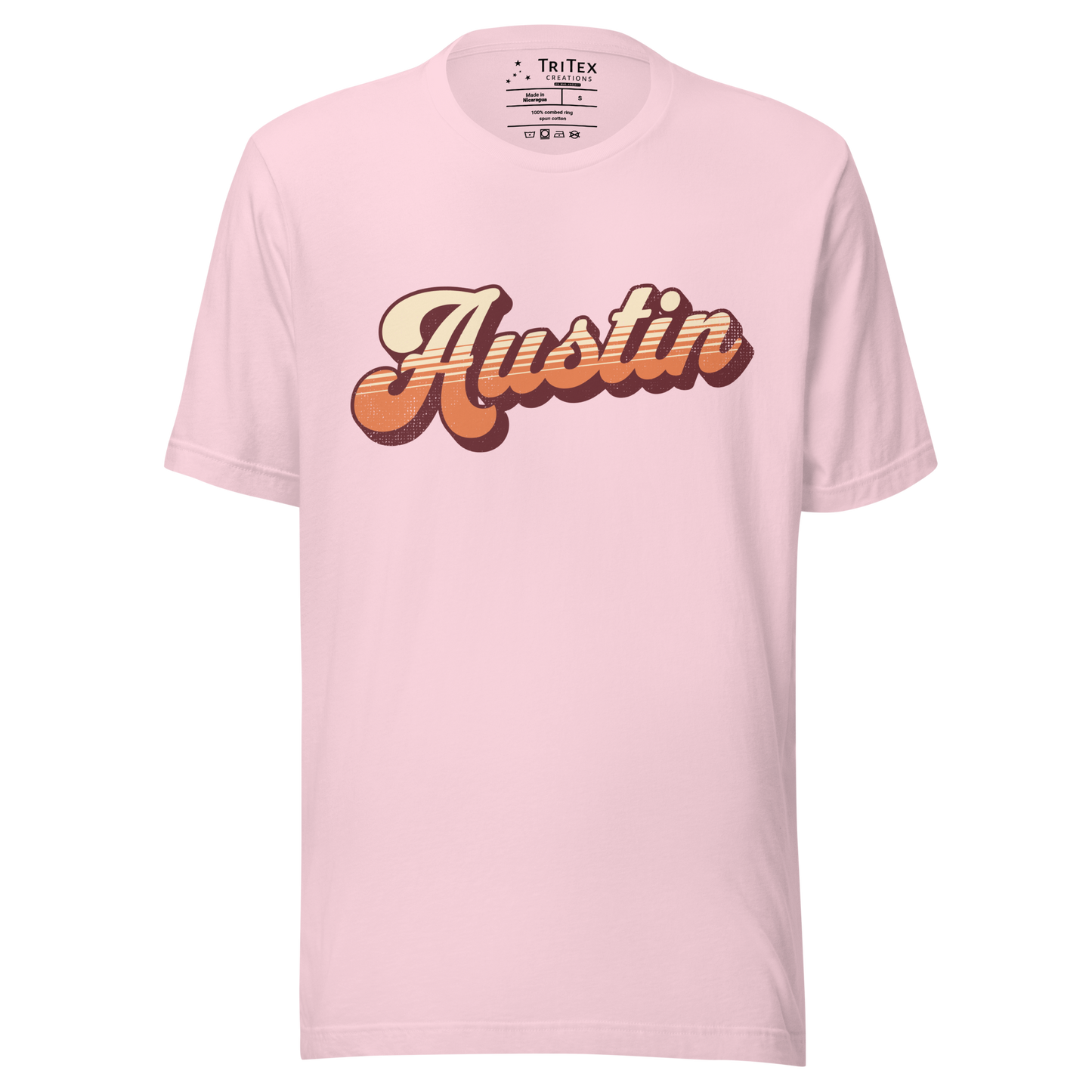 A soft pink t-shirt with a retro style Austin in a vintage font.