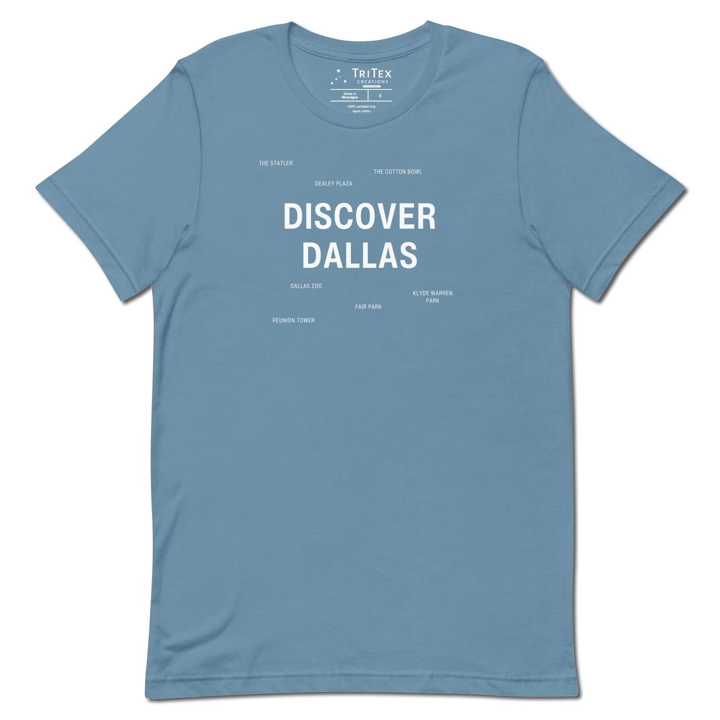 A steel blue t-shirt which reads "Discover Dallas" in big, bold text with smaller text elements naming Dallas landmarks.