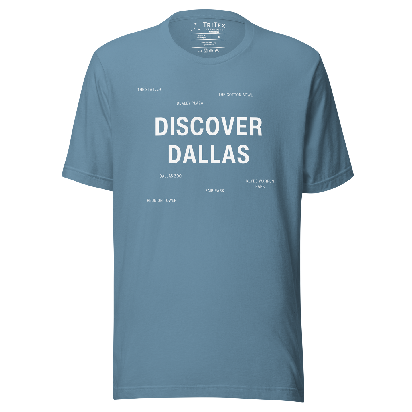 A steel blue t-shirt featuring "Discover Dallas" in big, bold type surrounded by smaller names of local landmarks.