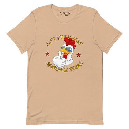 A tan t-shirt featuring an image of a chicken in sunglasses with the words "Ain't no cluckin' Texas". around in Texas!".