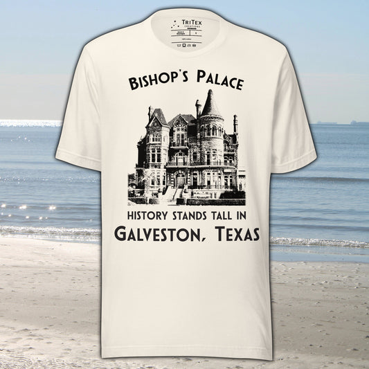 A vintage white t-shirt featuring a vintage-style picture of Bishop's Palace with the text "Bishop's Palace. History stands tall in Galveston, Texas".
