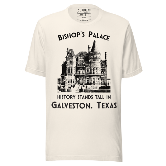 A vintage white t-shirt featuring a vintage-style picture of Bishop's Palace with the text "Bishop's Palace. History stands tall in Galveston, Texas".