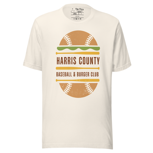 A vintage white t-shirt featuring a baseball styled like a cheeseburger with text that reads "Harris County Baseball & Burger Club".