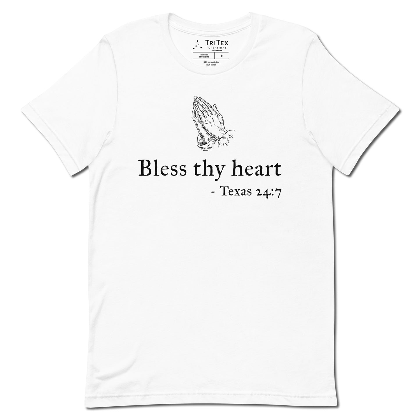 A white t-shirt featuring a vintage illustration of hands clasped in prayer with the words "Bless thy heart - Texas 24:7"