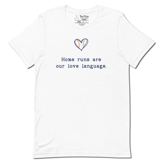 A white t-shirt picturing a heart-shaped baseball with the text "Home runs are our love language".