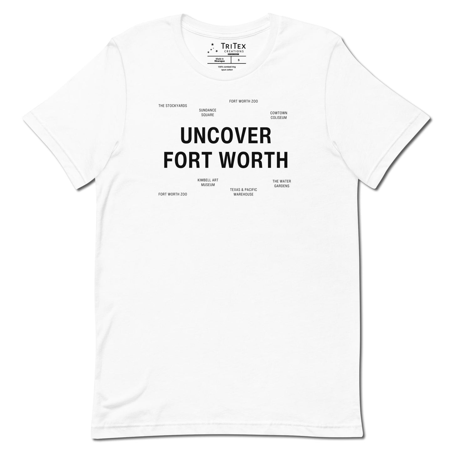 A white t-shirt which reads "Uncover Fort Worth" in big, bold text with smaller text elements naming Fort Worth landmarks.