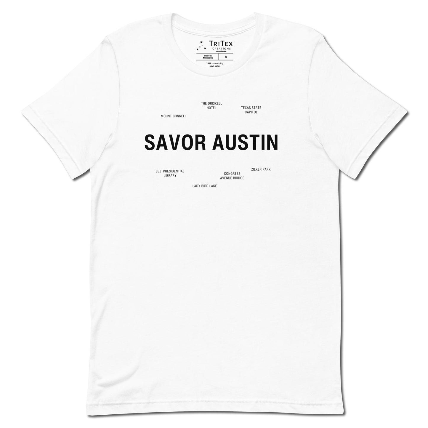 A white t-shirt which reads "Savor Austin" in big, bold text with smaller text elements naming Austin's landmarks.