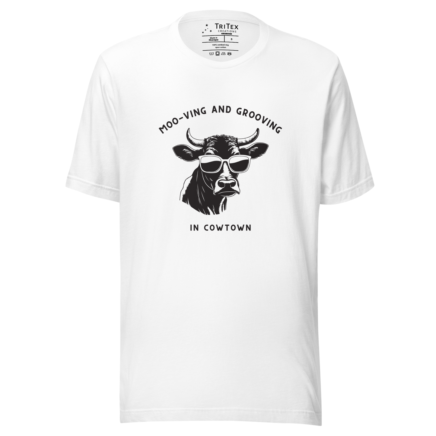 A white t-shirt featuring an illustration of a cow wearing sunglasses with the the text "Moo-vin' n' groovin' in Cowtown".